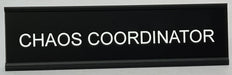 Black funny nameplate with 'CHAOS COORDINATOR' text on a white background