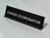 Funny desk sign with 'CHAOS COORDINATOR' text on a light gray background