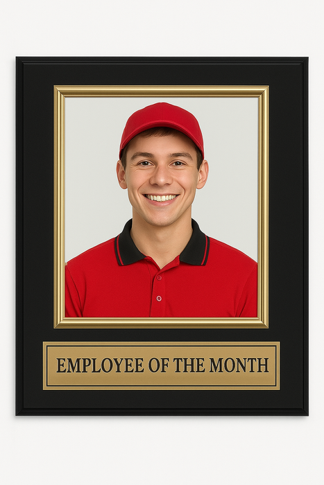 Framed photo of a person wearing a red cap and shirt with 'Employee of the Month' plaque.