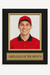 Framed photo of a person wearing a red cap and shirt with 'Employee of the Month' plaque.