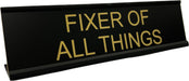 Fixer of all things funny desk office sign shown in black with gold text.