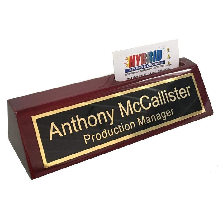 Custom name plate for desk shown holding business cards.