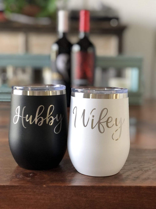 Wifey and Hubby stemless wine glasses in front of wine bottles.